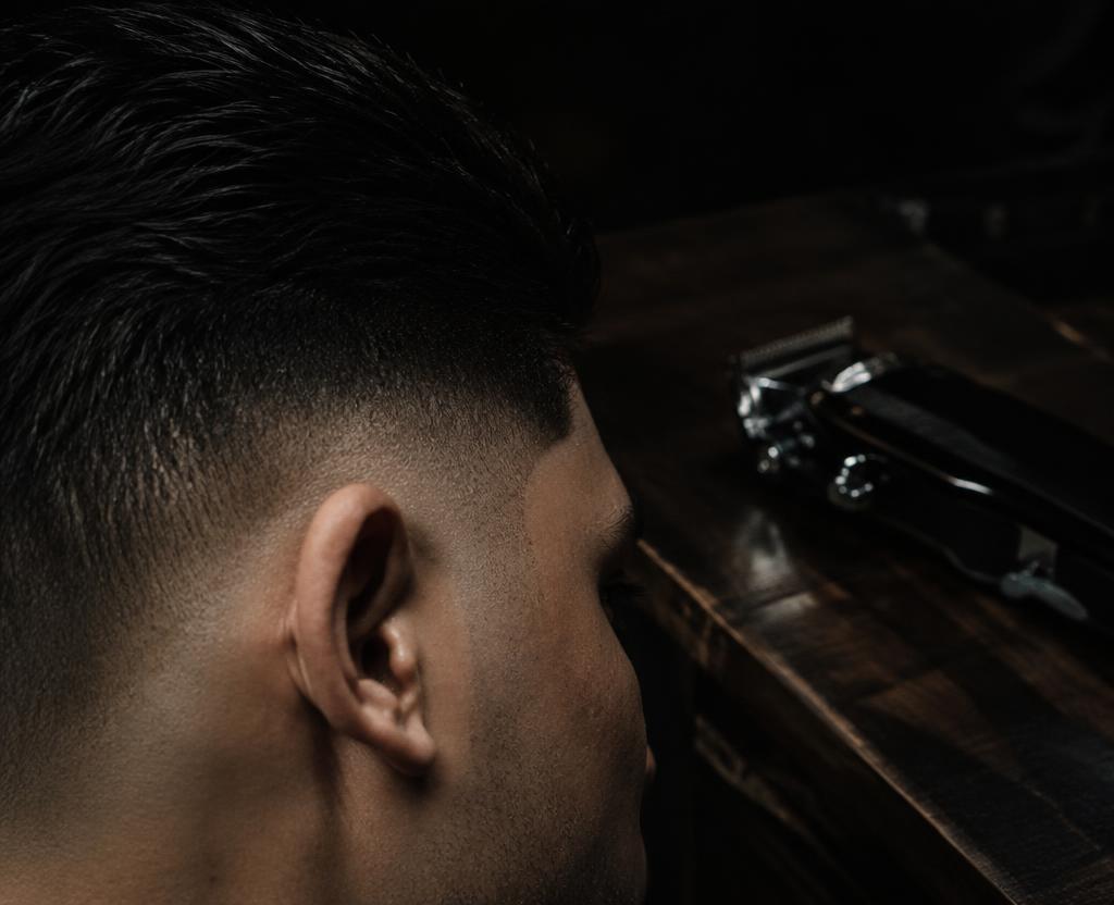Barber shaping a full beard at AJ's Barber Room on Alafaya Trail